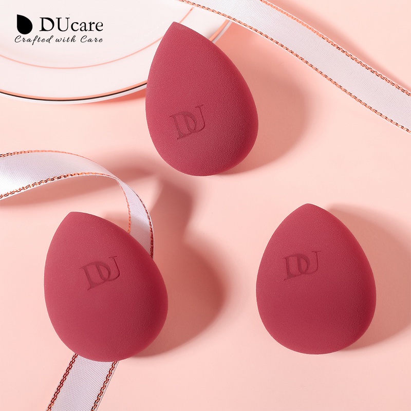 Ducare ฟองน้ําแต่งหน้าหยดน้ําพร้อมกล่องเก็บของพัฟเครื่องสําอางมืออาชีพสําหรับรองพื้นคอนซีลเลอร์บีบีครีมผสมฟองน้ําไข่