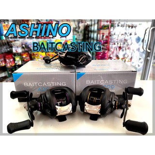 รอกตกปลา รอกหยดน้ำ Ashino A200/201 Baitcasting reel ตัวรอกสีดำ ขอบสปูนมีสีม่วง และสีทอง