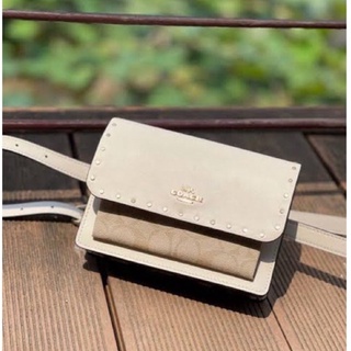 (ผ่อน0%) กระเป๋าสะพายข้าง FOLDOVER BELT BAG IN SIGNATURE CANVAS WITH RIVETS (COACH C3326) คาดอก คาดเอว ลายซี สีขาว