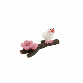 Cream bird on a branch with flower figure.