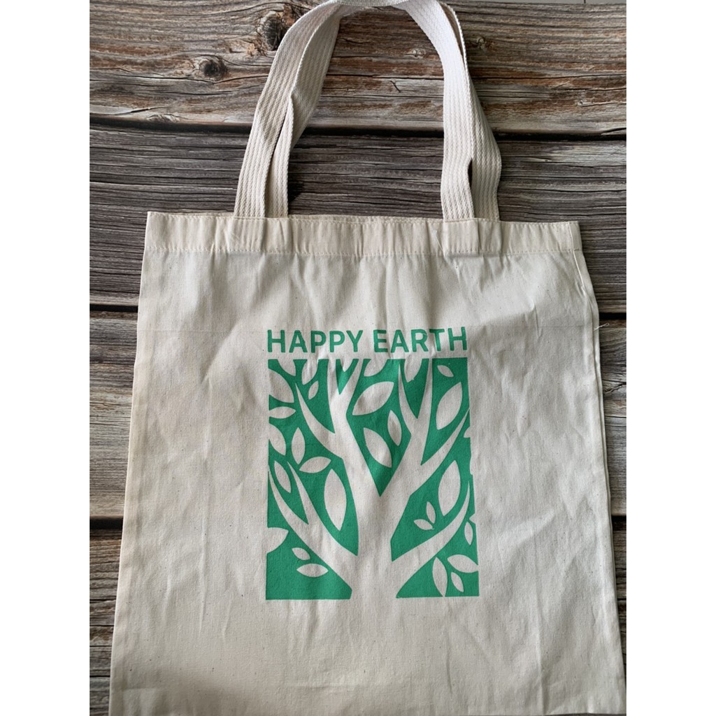 กระเป๋าผ้า สกรีนลาย happy earth รักษ์โลก มีสีขาวและสีครีม