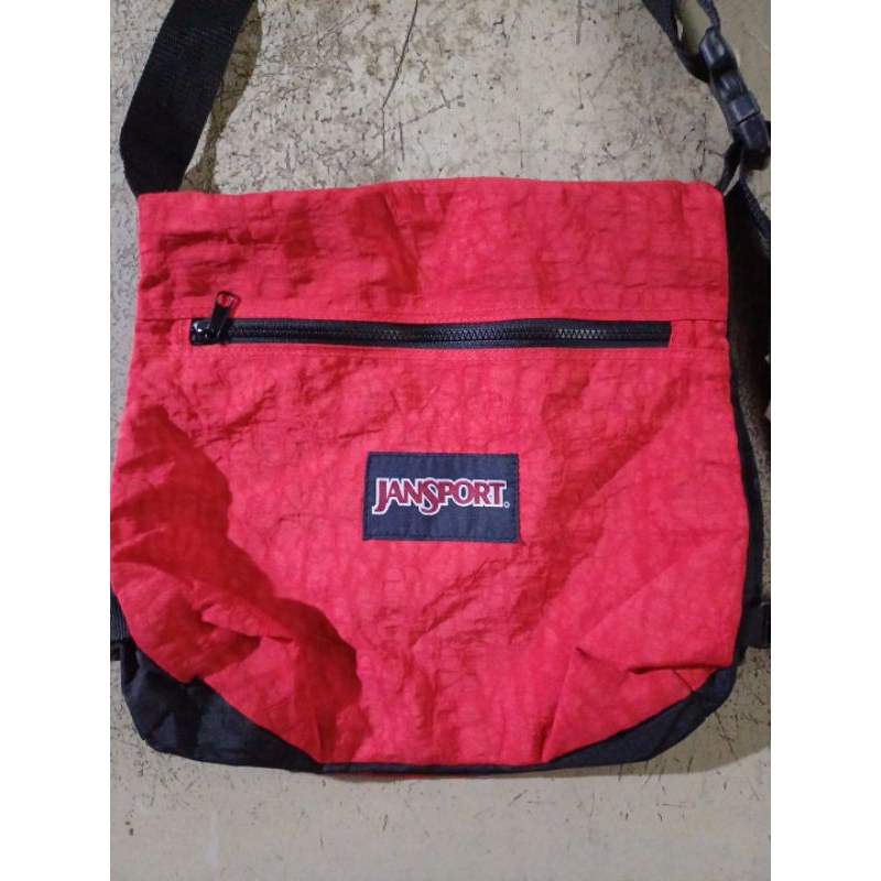 MERAH Jansport กระเป๋าสะพายข้างสีแดง