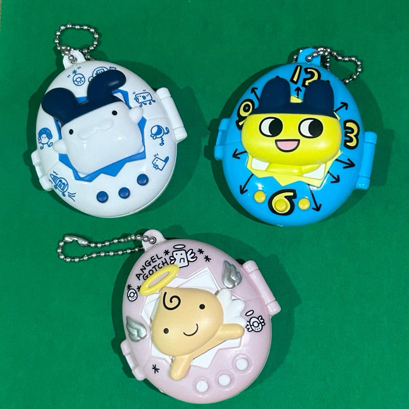 Gantungan ไม้แขวนเสื้อ Gacha Tamagotchi กรณี Angelgotchi Mametchi Mimitchi Gachapon Kawaii น่ารักพวง