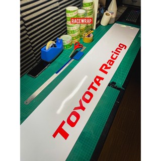 new design สติกเกอร์ติดรถยนต์ คาดหน้า/บังแดด " TOYOTA RACING " พื้นขาวอักษรแดง