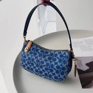 Coach Swinger in Signature Denim CA103