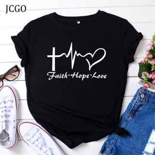 Tee JCGO ฤดูร้อนผ้าฝ้ายผู้หญิงเสื้อยืด S-5XL อเนกประสงค์แขนสั้นหัวใจรักพิมพ์กราฟิกเสื้อยืดท็อปส์ซูลําลองโอคอเสื้อผ้าผู้ห