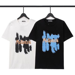 เสื้อยืดแขนสั้นลําลอง ผ้าฝ้าย พิมพ์ลายกราฟฟิติตัวอักษร MC แฟชั่นสตรีท สําหรับผู้ชาย และผู้หญิง