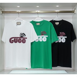 Gucc เสื้อยืดแขนสั้น ผ้าฝ้าย พิมพ์ลาย แฟชั่นสําหรับผู้ชาย และผู้หญิง