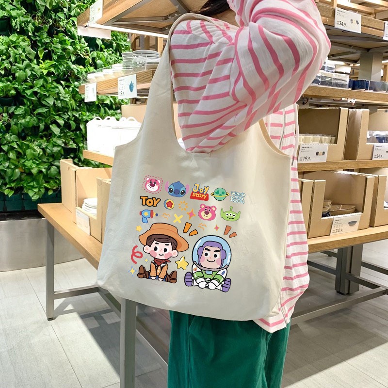 กระเป๋าสะพายไหล่ ถุงช้อปปิ้ง ผ้าแคนวาส ลายการ์ตูน Toy Story Winnie The Pooh สำหรับผู้หญิง