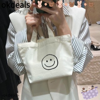 Okdeals กระเป๋าถือ ผ้าแคนวาส ลายหน้ายิ้ม ขนาดเล็ก ใช้ซ้ําได้ สีขาว สําหรับผู้หญิง