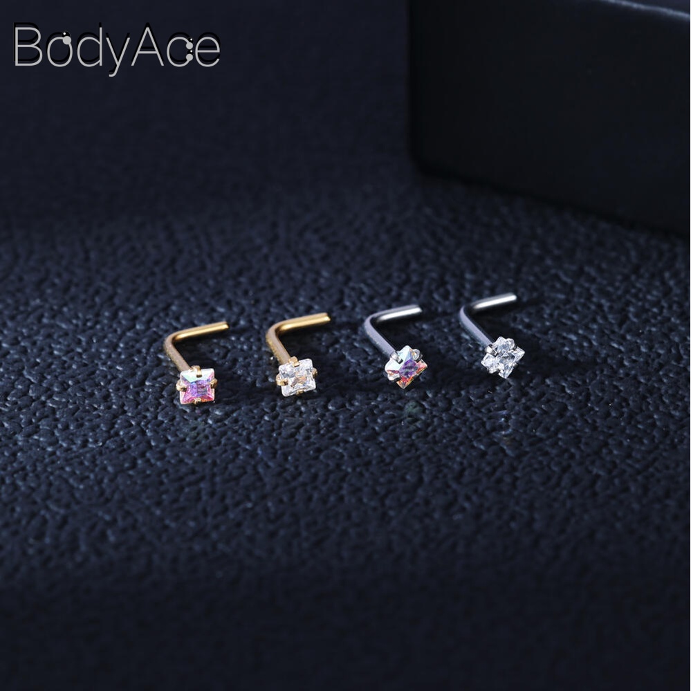 Bodyace 1 ชิ้น 0.8 / 1.0 มม. ลูกบาศก์เพทายจมูกกระดุมสแตนเลสรูปตัว L เจาะจมูกหัวใจดาวสี่เหลี่ยมเจาะรูจมูก