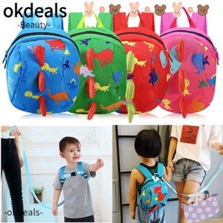 OKDEALS กระเป๋าเป้สะพายหลัง พร้อมสายรัด ป้องกันการสูญหาย รูปไดโนเสาร์ เพื่อความปลอดภัย สําหรับเด็ก