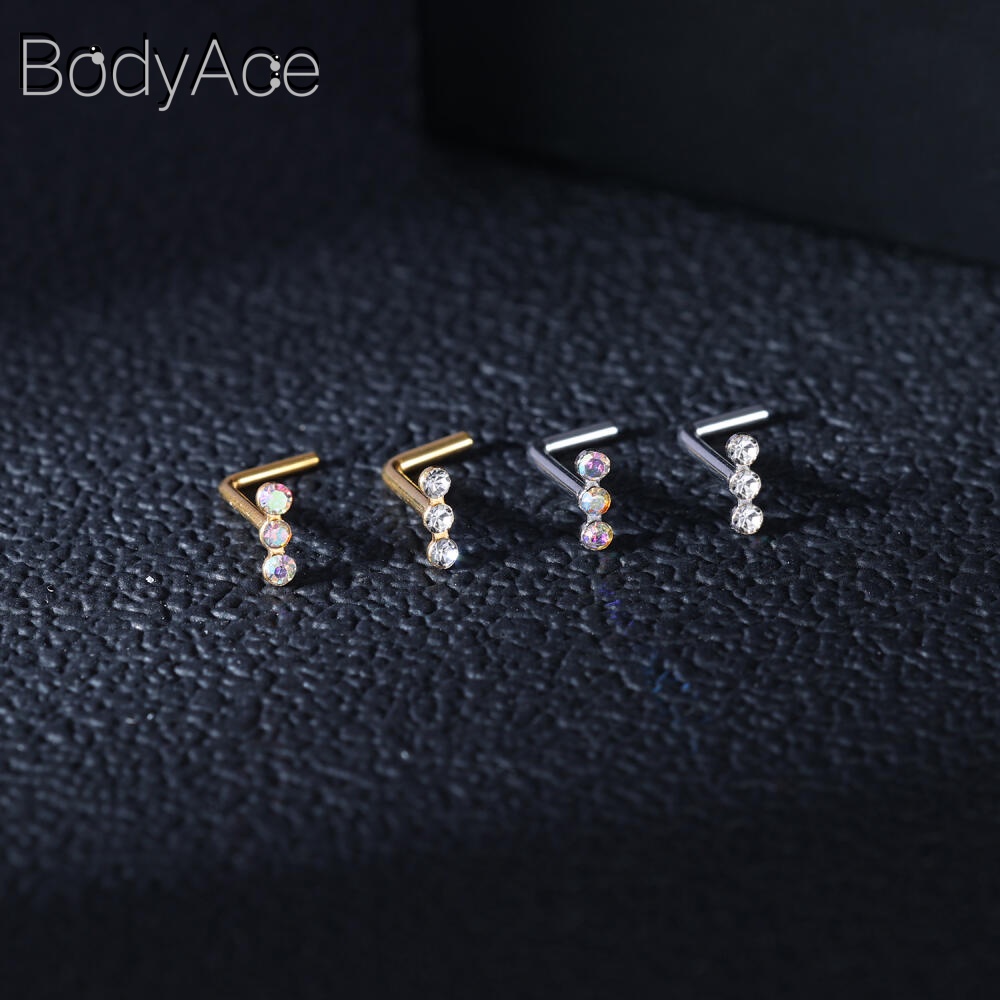 Bodyace 1 ชิ้น 0.8 / 1.0 มม. ลูกบาศก์เพทายจมูกกระดุมสแตนเลสรูปตัว L เจาะจมูกหัวใจดาวสี่เหลี่ยมเจาะรูจมูก