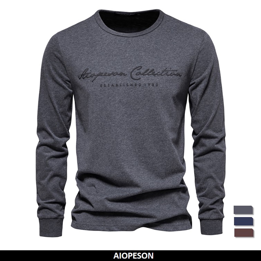 Aiopeson เสื้อยืดลําลอง แขนยาว ผ้าฝ้าย 100% พิมพ์ลายตัวอักษร สีพื้น แฟชั่นฤดูใบไม้ผลิ สําหรับผู้ชาย