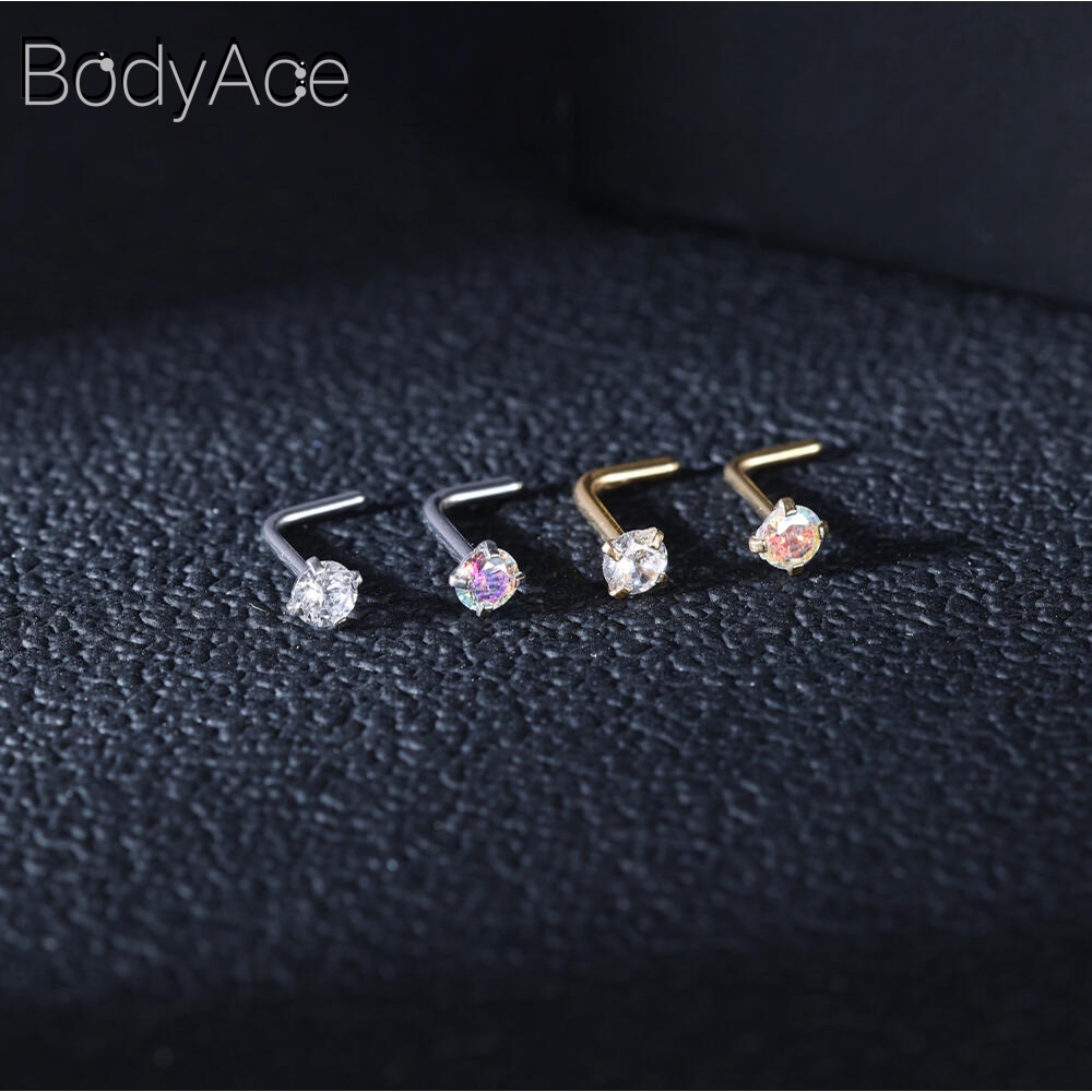 Bodyace 1 ชิ้น 0.8 / 1.0 มม. ลูกบาศก์เพทายจมูกกระดุมสแตนเลสรูปตัว L เจาะจมูกหัวใจดาวสี่เหลี่ยมเจาะรูจมูก