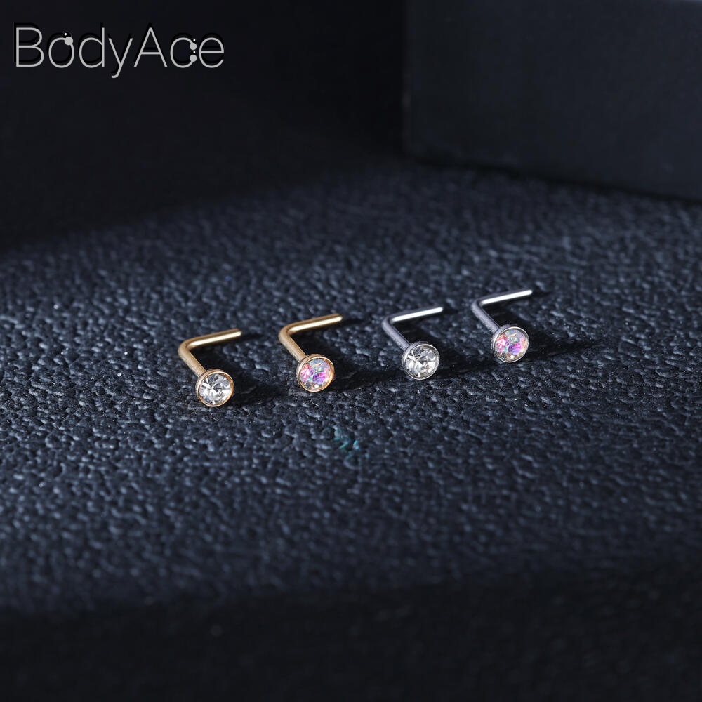 Bodyace 1 ชิ้น 0.8 / 1.0 มม. ลูกบาศก์เพทายจมูกกระดุมสแตนเลสรูปตัว L เจาะจมูกหัวใจดาวสี่เหลี่ยมเจาะรูจมูก