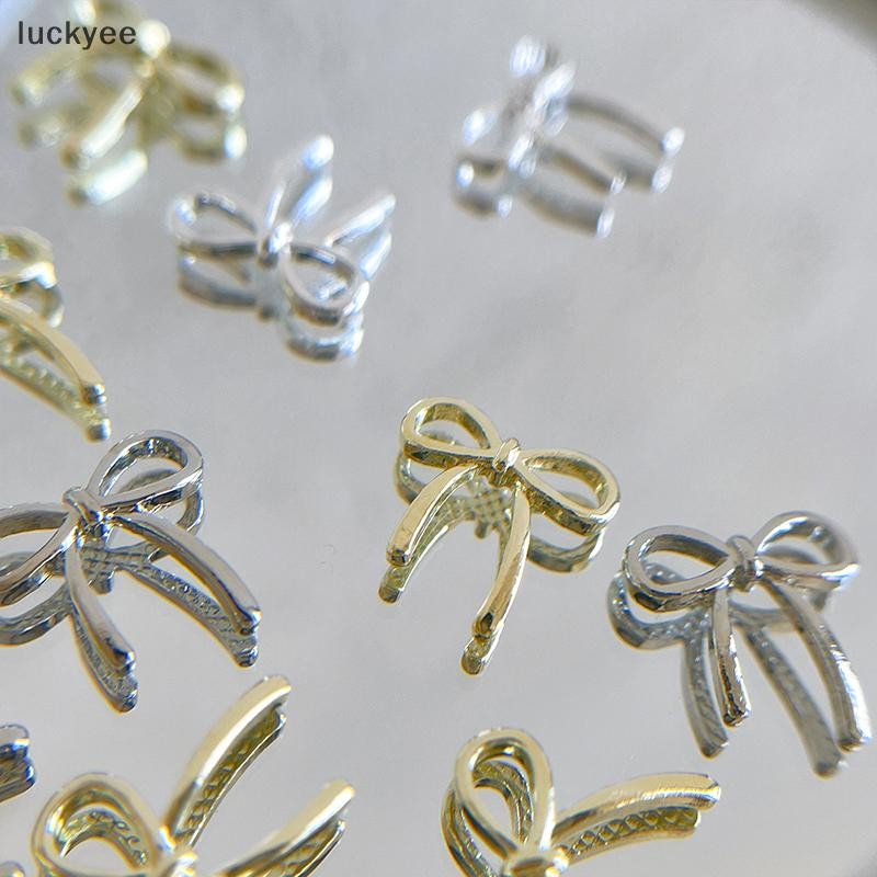 Luckyee 10 ชิ้น Bow Deco เล็บ Charm 3D เงิน/ทอง Bowknot ริบบิ้นตกแต่งเล็บอะไหล่ DIY หรูหราเล็บอุปกรณ์เสริม TQ