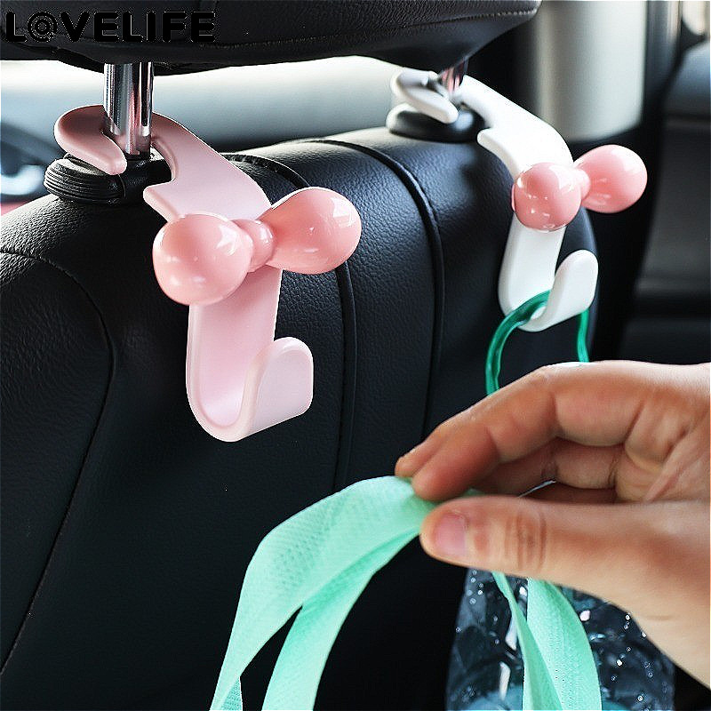 [ โดดเด่น ] ตะขอเกี่ยวเบาะหลังรถยนต์ - ขายึดของกระจุกกระจิกกระเป๋ามัลติฟังก์ชั่น - ตะขอโบว์สีชมพูน่ารัก - ที่ยึดกุทัณฑ์แบบไม่ทําเครื่องหมาย - ขายึดเก็บของสากล - อุปกรณ์ป
