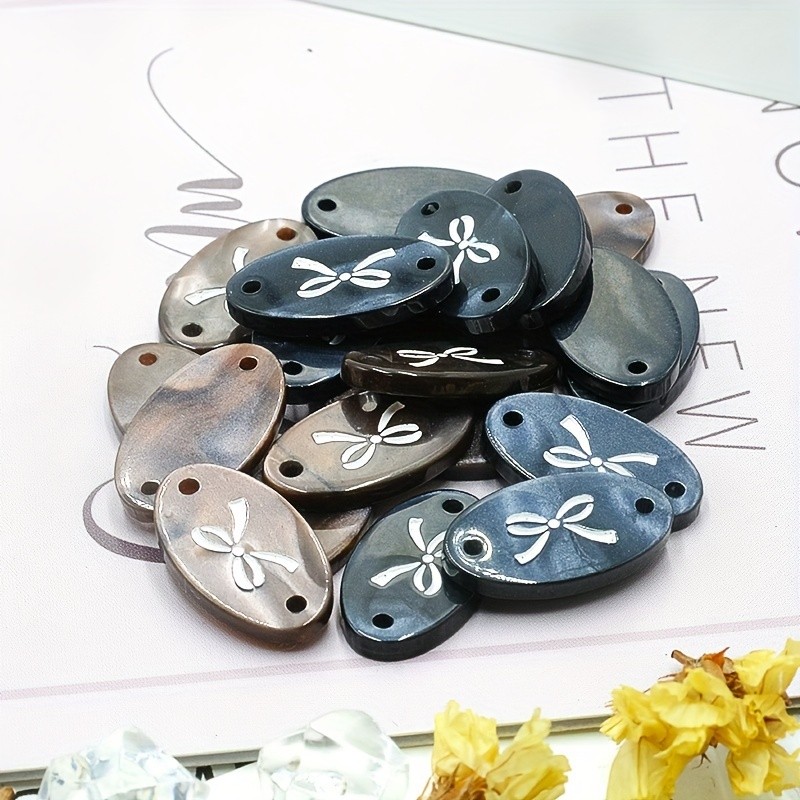 10ชิ้น18มิลลิเมตร ทําเอง เสื้อเรซิ่นแท็กปุ่มสีดําสีกาแฟ มุก รูปไข่แท็กปุ่มเสื้อผ้าเย็บอุปทาน