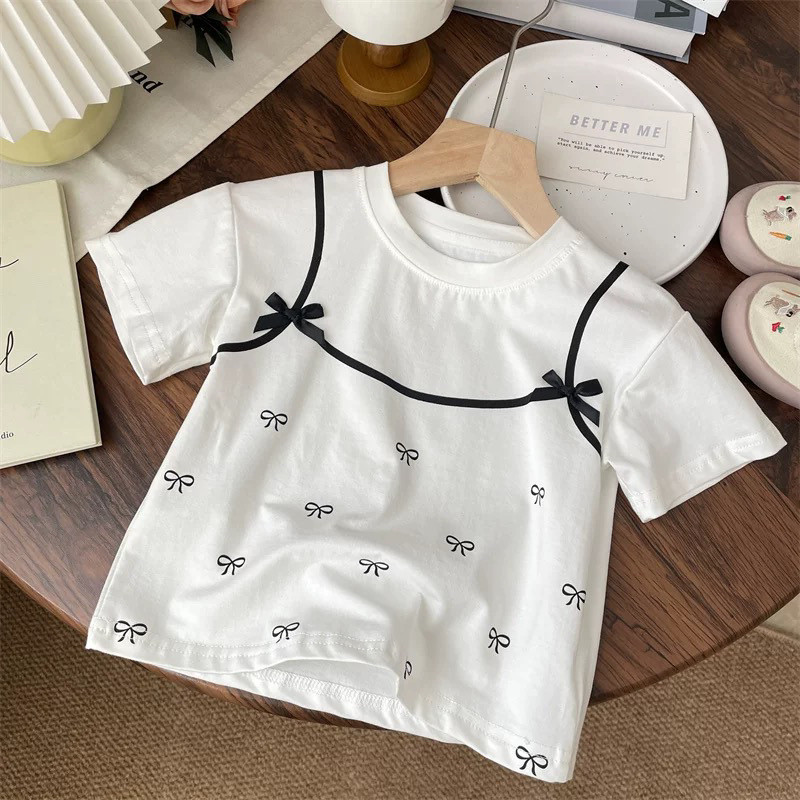 ฤดูร้อน เสื้อยืดแขนสั้นสำหรับเด็กผู้หญิง ลายโบว์สีดำ เสื้อผ้าเด็กสบายๆ