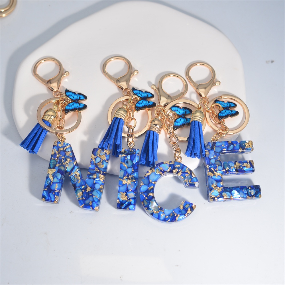 พวงกุญแจพู่เรซิ่น รูปผีเสื้อ สีฟ้า 26 Initials A-Z น่ารัก แฟชั่น สําหรับผู้หญิง ผู้ชาย กระเป๋าเป้สะพายหลัง รถยนต์ กระเป๋าถือ