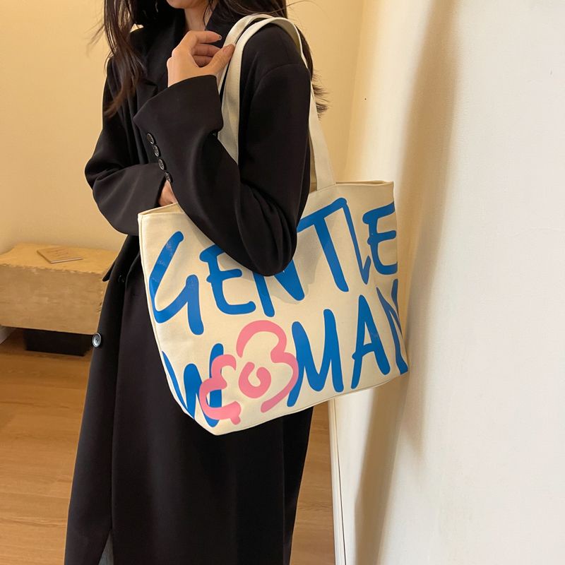 กระเป๋าสะพายไหล่ กระเป๋าถือ ผ้าแคนวาส พิมพ์ลายตัวอักษร แฟชั่นเรียบง่าย สไตล์เกาหลี สําหรับนักเรียนหญิง
