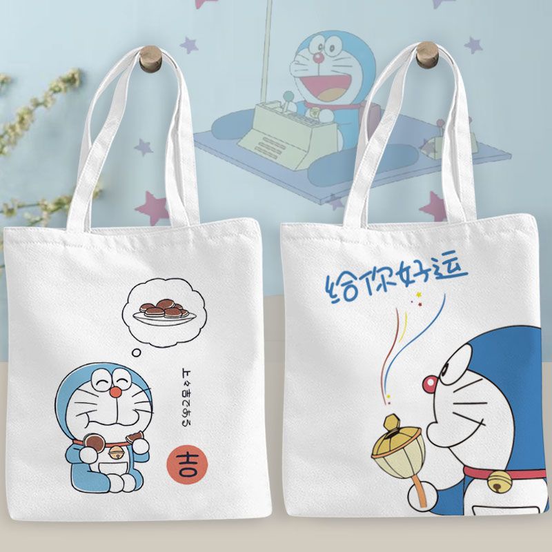 กระเป๋านักเรียน ผ้าแคนวาส ขนาดใหญ่ จุของได้เยอะ ลายการ์ตูนโดราเอมอน แมวอ้วนน่ารัก สีฟ้า สําหรับนักเรียน