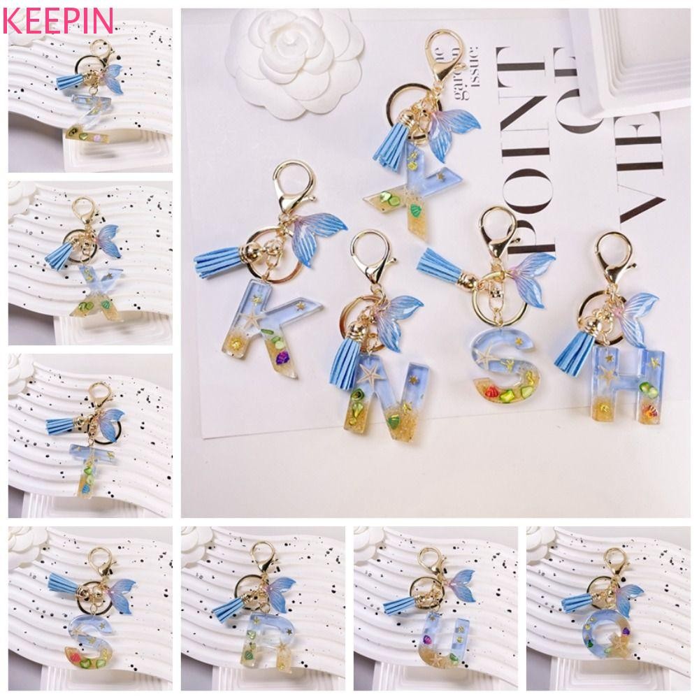 Keepin Blue Ocean Letter พู่สีฟ้า 26 ตัวอักษร Fishtail จี้, A ถึง Z พวงกุญแจเรซิ่น 26 ตัวอักษร พวงกุญแจตกแต่งกระเป๋าถือ