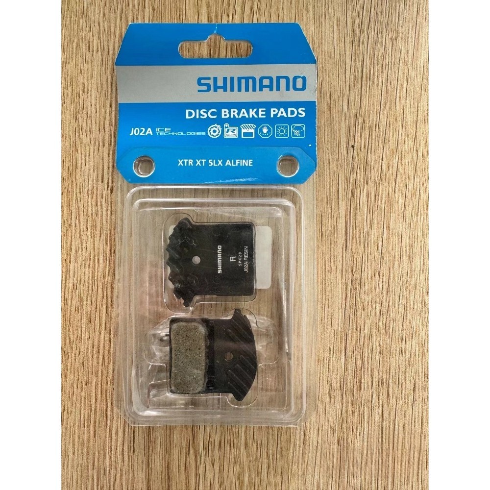 SHIMANO J02A ผ้าเบรคสําหรับจักรยาน MTB Ice Technologies 2 ลูกสูบโลหะเรซิ่นสําหรับ Deore SLX XT XTR M7100 M8100 อะไหล่เดิม
