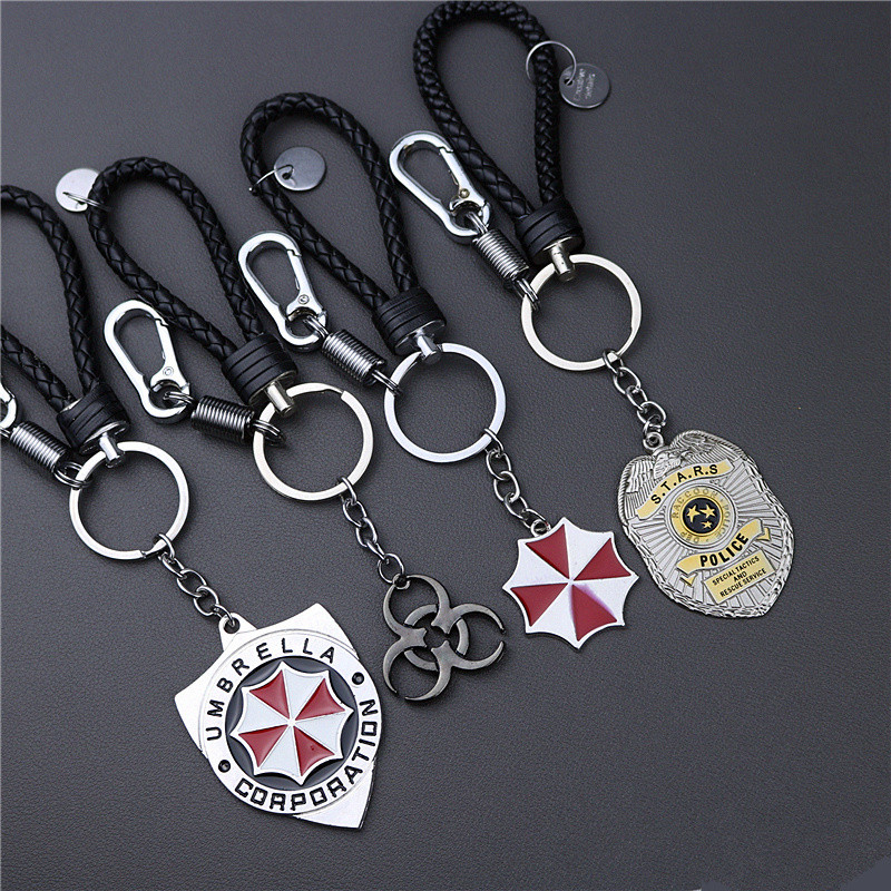 Resident Evil พวงกุญแจคําเตือนป้ายรังสีนิวเคลียร์ร่มสีแดงบริษัทจี้พวงกุญแจรถยนต์ของขวัญวันเกิด