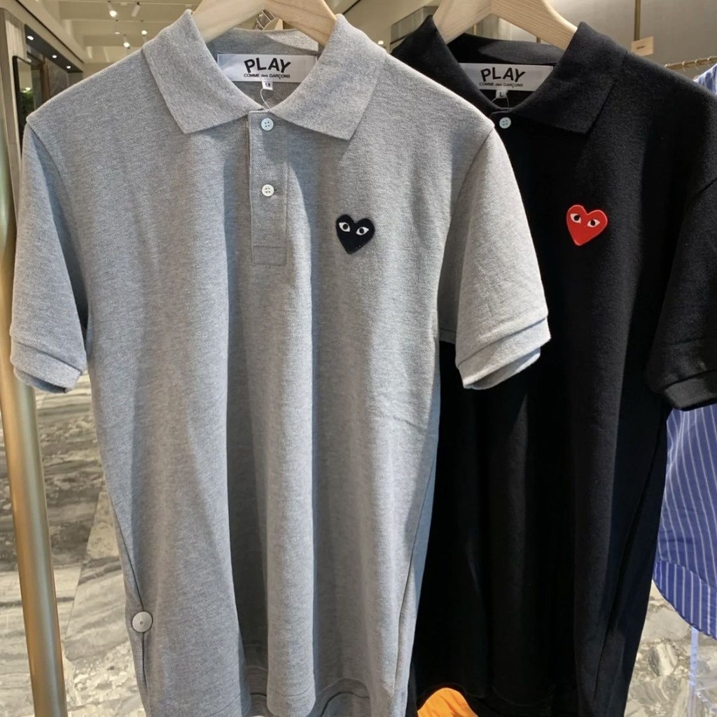 ซีดีจี เสื้อยืดคอปกโปโลรักแบรนด์อินเทรนด์สําหรับผู้ชายและผู้หญิงเสื้อโปโลกีฬาคอปกหลวมเล่นแขนสั้น