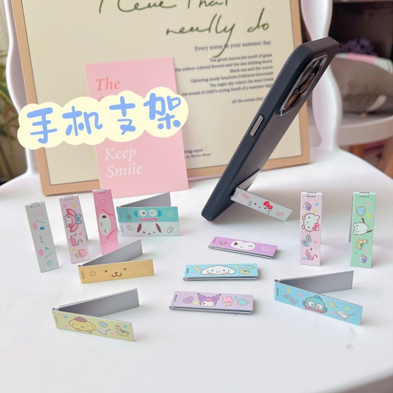 ขาตั้งโทรศัพท์มือถือญี่ปุ่นแบบพกพาที่มองไม่เห็นกรอบแบนขาตั้งโลหะพับได้การ์ตูนน่ารักเดสก์ท็อปสนับสนุน