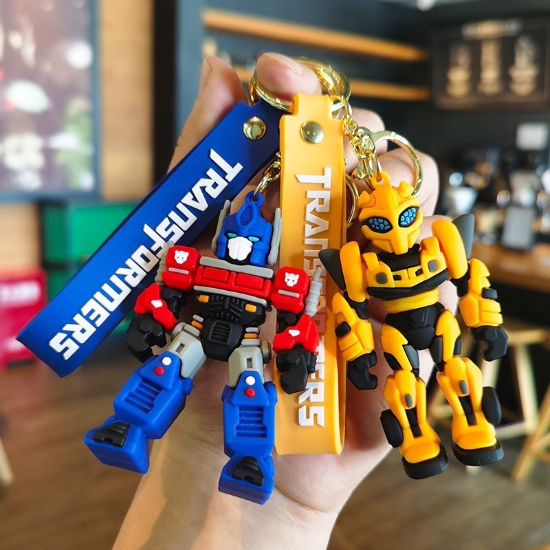 Transformers พวงกุญแจตัวเลขการกระทํา Optimus Prime Bumblebee จี ้ อะนิเมะแหวนกุญแจรถการ ์ ตูนตุ ๊ กตากระเป ๋ าเป ้ สะพายหลังจี ้ ของเล ่ นของขวัญ