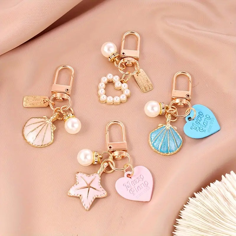 อินเทรนด ์ ปลาดาวเปลือกหอยจี ้ พวงกุญแจประณีตหัวใจมุกแหวนโลหะห ้ าแฉก Star ผู ้ ถือกุญแจรถหูฟังเครื ่ องประดับ