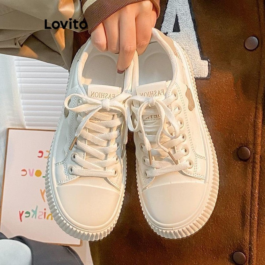 Lovito รองเท้าผ้าใบผู้หญิง แต่งปะ ลายดอกไม้ สีพื้น สไตล์ลำลอง LFA41332