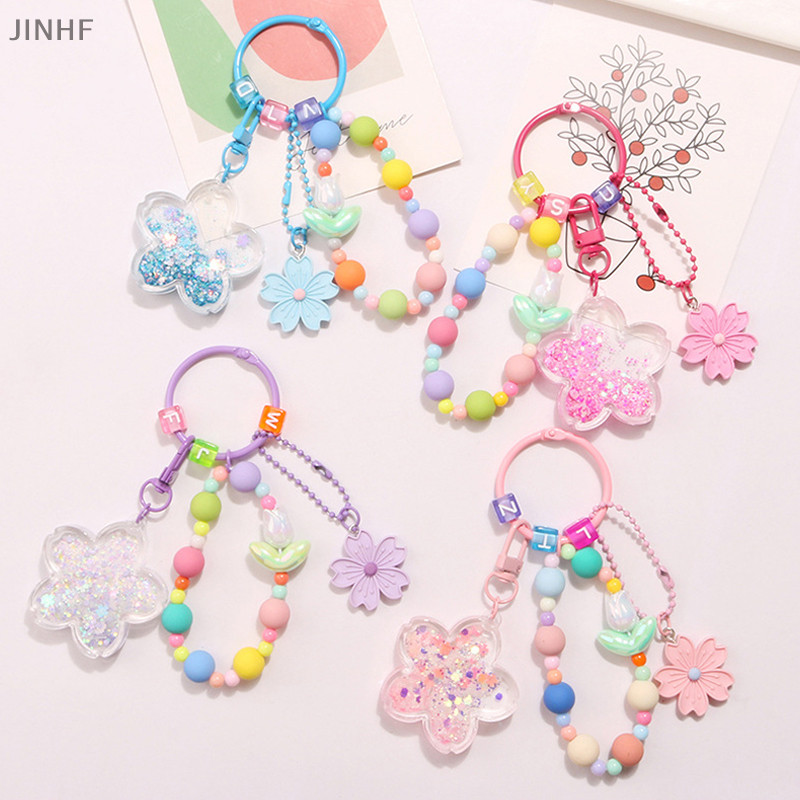 [ดีที่สุดซื้อร้านค้า] ใหม่น้ํามันไหลทรายพวงกุญแจดอกไม้ใหญ่กับน่ารักที่มีสีสันซากุระอุปกรณ์เสริมจี้ผู้หญิงหูฟังกรณีกระเป๋าตกแต่งหุ้นใ
