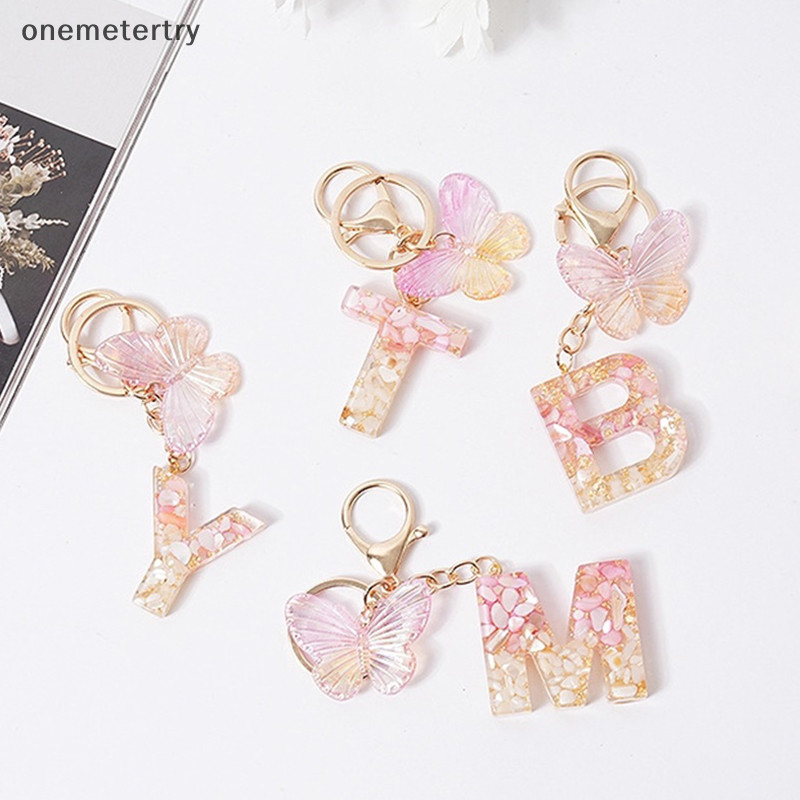 Onem สีชมพู Dream ผีเสื้อ 26 ตัวอักษร Z เรซิ่นพวงกุญแจ 26 เริ่มต้นหินสีขาว Gold Leaf จี้พวงกุญแจกระเป๋าเป้สะพายหลัง Charm กระเป๋า Decor n
