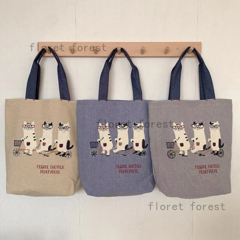 【แบรนด์ญี่ปุ่น】Kusuguru สินค้าจริง แมวแว่นตาปักลาย กระเป๋าสะพาย/ถือ สำหรับเรียนและช้อปปิ้ง