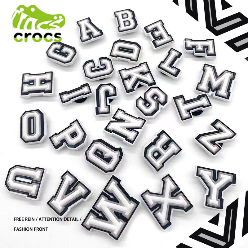 สไตล ์ ใหม ่ รองเท ้ าดอกไม ้ Jibbitz crocs Letter รองเท ้ าหัวเข ็ มขัด Carlo Chi รองเท ้ าจํานวนอุปกรณ ์ เสริมตกแต ่ งหัวเข ็ มขัดการ ์ ตูน Zhibixing