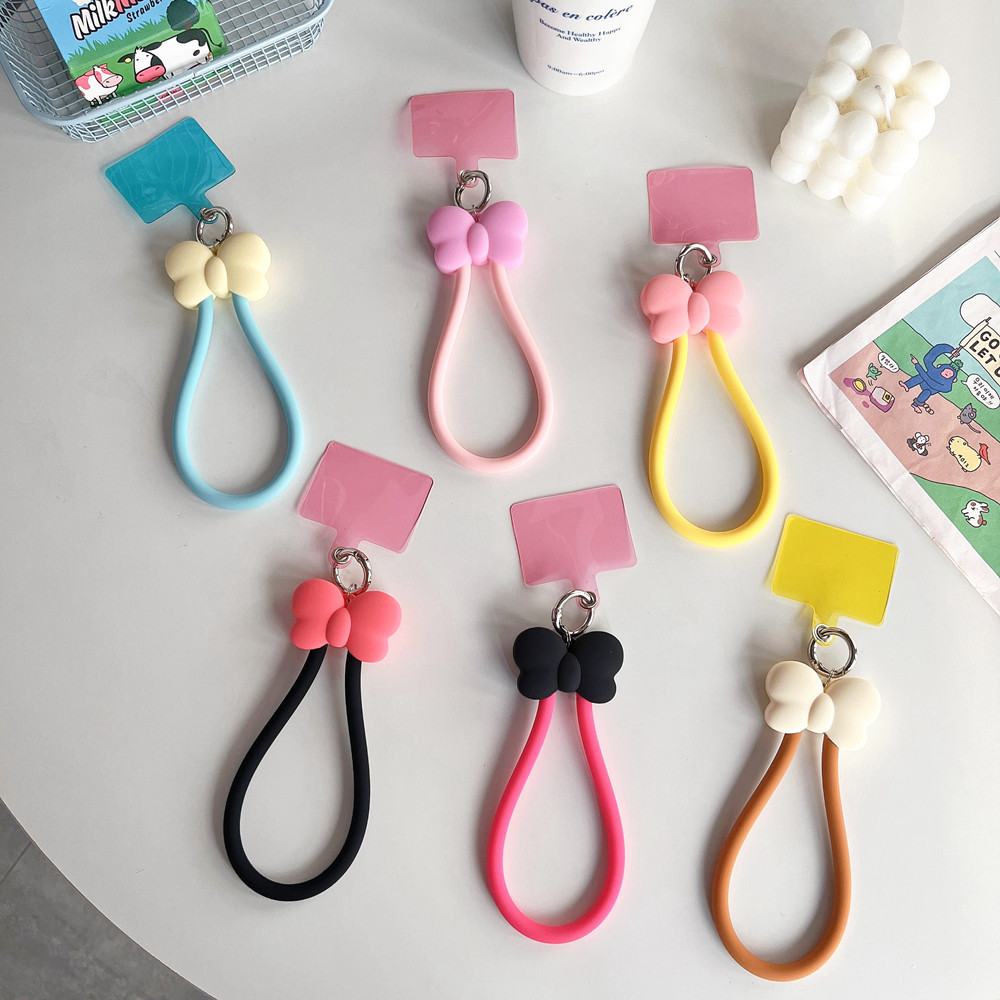 Ins สไตล ์ สีทึบ 3D โบว ์ สาวหัวใจคลิปโทรศัพท ์ มือถือ Creative Anti Drop สายรัดข ้ อมือซิลิโคนเหมาะสําหรับโทรศัพท ์ ทั ้ งหมดกรณีปะเก ็ นการ ์ ดจี ้