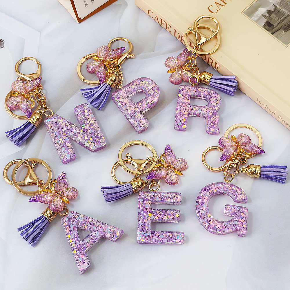 1 ชิ้น Glitter สีม่วงเลื่อม Filled AZ พวงกุญแจแฟชั่นผีเสื้อตัวอักษร Keyrings ของขวัญเพื่อนของที่ระลึกอุปกรณ์เสริม
