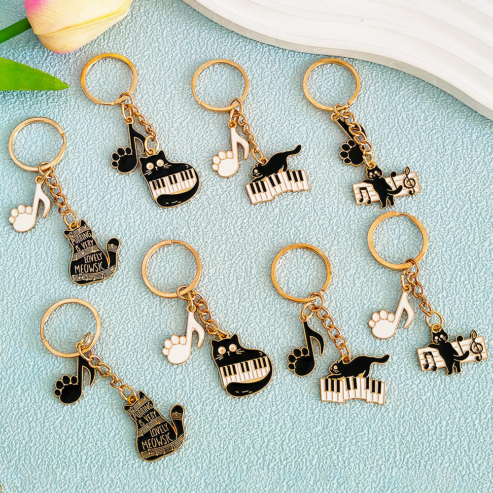 เปียโนที่เรียบง่ายแมวพวงกุญแจโลหะการ์ตูนบันทึกเพลงคิตตี้พวงกุญแจรถที่เก็บกุญแจของขวัญเพื่อนเครื่องประดับของที่ระลึก