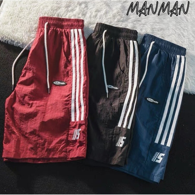 MANMAN กางเกงขาสั้นผู้ชาย ชุดกีฬาสันทนาการ มีลายทาง แบบหลวม แมทช์ลุคง่าย กางเกงยืด