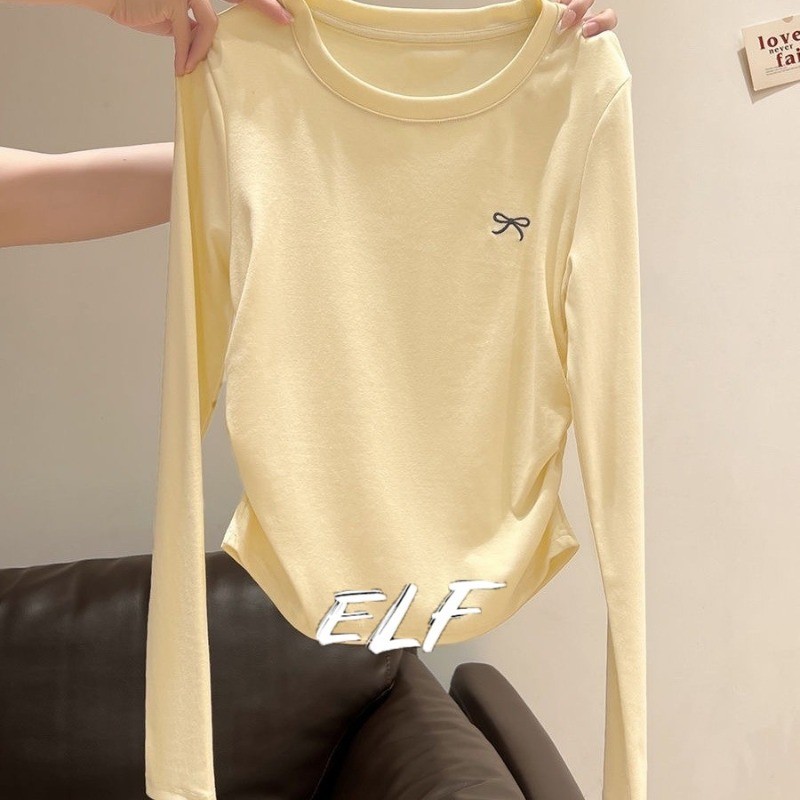 ฤดูใบไม้ร่วงสไตล์เกาหลีหวานเรียบง่ายกอดแฟชั่นโบว์แขนยาวเสื้อยืดผู้หญิง