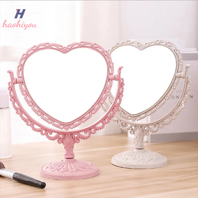 <haohiyou> กระจกแต่งหน้าตั้งโต๊ะรูปหัวใจแต่งหน้าโต๊ะเครื่องแป้งแบบพกพากระจกโต๊ะเครื่องแป้งสองด้านกระจกมือเครื่องสําอางกระจกขนาดกะทัดรัดสําหรับผู้หญิงดี