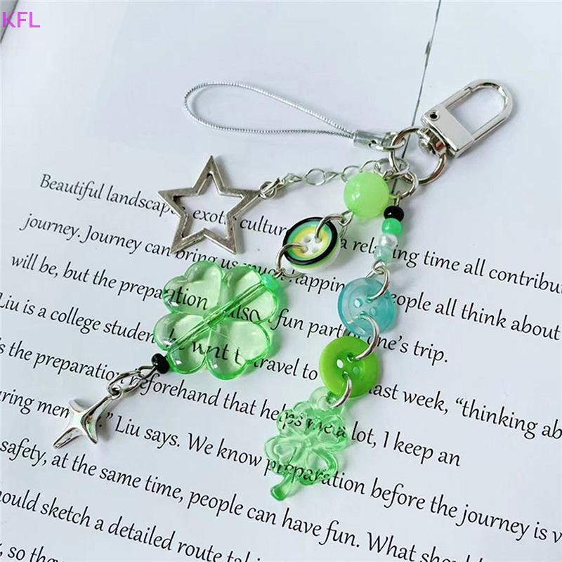 (KFL) แฟชั่น Four Leaf Clover โทรศัพท์พวงกุญแจปุ่มที่มีสีสันจี้ลูกปัด Ch พวงกุญแจกระเป๋าเป้สะพายหลังแขวนตกแต่งขายร้อน