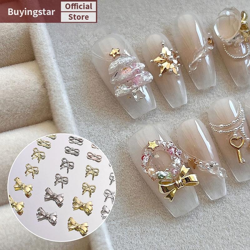 Zcx 10PCS เล็บ Ch 3D คริสตัล Rhinestones Bow Nail Art เครื่องประดับโลหะผสม Bow Tie Gold Shinny เล็บอุปกรณ์เสริม Salon เล็บเครื่องมือ VO