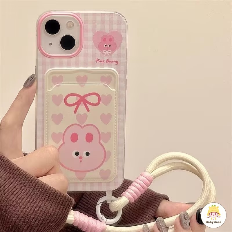 โบว์ผูกหัวใจกระต่ายสีชมพูสุ ช่องใส่บัตรพร้อมสายคล้อง เคสIPhone 16 11 13 15 12 14 Pro Max XR XS X Max 7 14 15 8 Plus SE