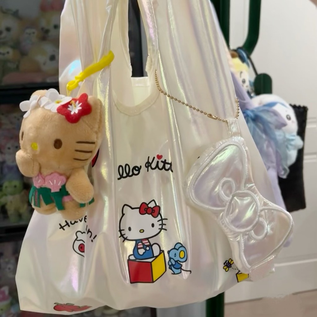 น่ารัก Hello Kitty เลเซอร์กระเป๋าถือสาวหัวใจสร้างสรรค์เสื้อกั๊กแบบพกพามือถือออกกระเป๋าช้อปปิ้งถุงเก็บ