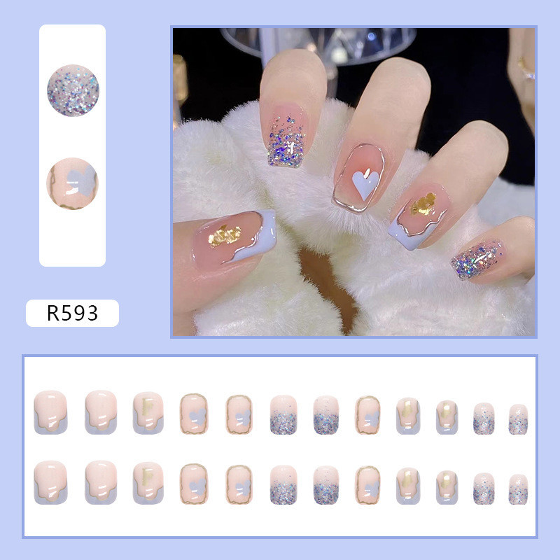 เล็บปลอมชุดเล็บปลอมทรงสี่เหลี่ยม 24 ชิ้นพร้อมการออกแบบกราฟฟิตีสีม่วงน่ารักและเล็บปลอมลายสีทองพร้อมกาวเยลลี่-ร593